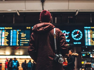A traveller checking the departures board at an airport