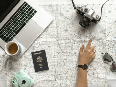 A person pointing at a paper map while planning a trip