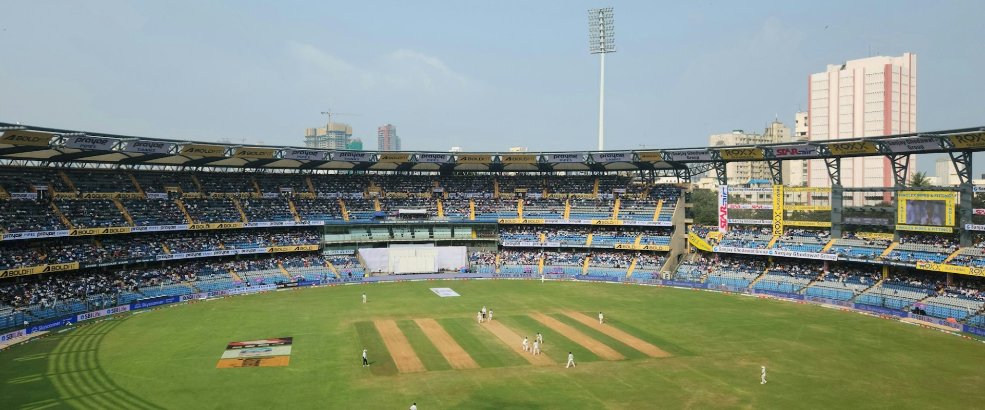 A packed cricket stadium full of spectators during a match