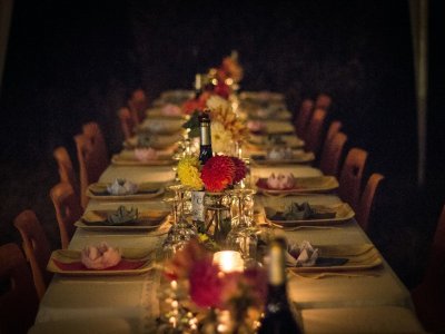 A long banquet table with flowers and candlelight