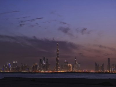 Dubai city lights reflected in the water at night