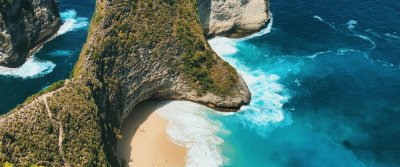 Aerial view of dramatic cliffs and surf along the Bali coastline